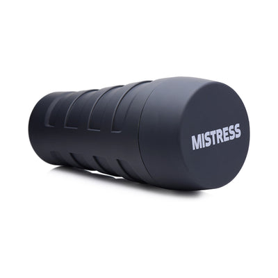 Black cylindrical stroker case with "MISTRESS" branding on the cap, designed for discreet storage and use.