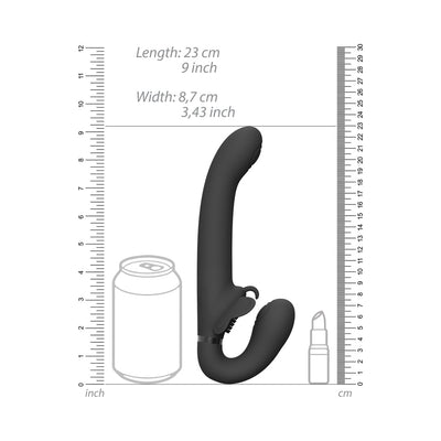 Black silicone strapless strap-on vibrator with curved design and clitoral stimulator, shown with size comparison to a soda can and lipstick.