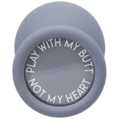 Gray silicone butt plug with a wide base featuring the phrase "Play with my butt not my heart" in white letters.
