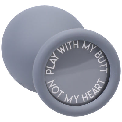 Gray silicone butt plug with a rounded tip and a wide base featuring the phrase "Play with my butt not my heart" in white text.