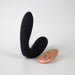 Black silicone C-shape vibrating plug with a rose gold remote control on a white background.