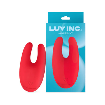 Red silicone Mini Bunny vibrator by Luv Inc with dual prongs shown next to its blue packaging box.