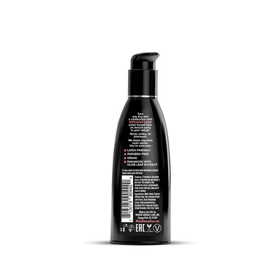 Black pump bottle of Wicked Aqua water-based lube with birthday cake flavor, featuring product details and usage instructions on the label.