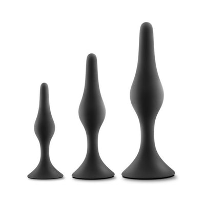 Set of three black silicone beginner anal plugs in small, medium, and large sizes with tapered shapes and flared bases.