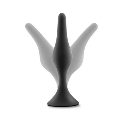 Black silicone beginner anal plug with tapered shape and flared base shown with motion blur effect on white background.