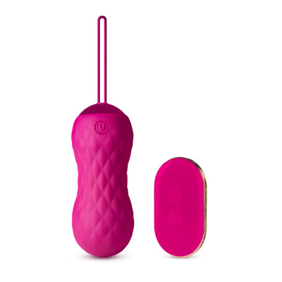 Pink textured insertable bullet vibrator with pull loop and matching wireless remote control on white background.