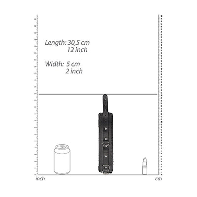 Black and white plush bonded leather hand cuff with adjustable strap and metal ring shown with size measurements.