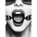 Close-up black and white image of a person wearing a black silicone ring gag with adjustable leather straps and metal clasps.