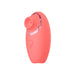 Coral pink compact clitoral vibrator with silicone texture and USB rechargeable design.