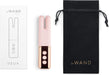 Le Wand Deux dual-ended mini vibrator in pink with rose gold accents, packaging box, and black drawstring storage pouch.
