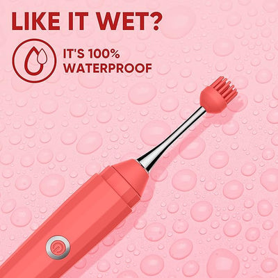 Coral-colored Luv Inc OP10 Orgasm Pen with silicone tip on a water droplet background highlighting its 100% waterproof feature.