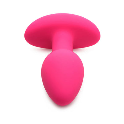 Vibrant pink silicone butt plug with smooth tapered tip and wide base for secure, comfortable wear.