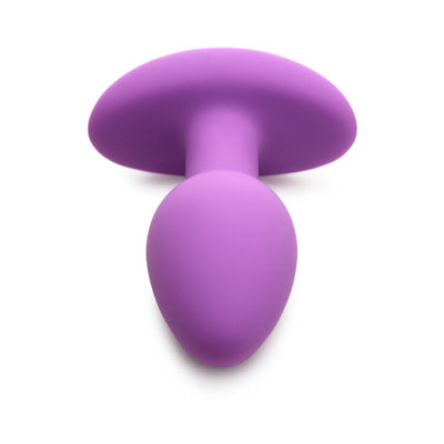 Vibrant violet silicone butt plug with smooth, tapered shape and wide base for secure, comfortable wear.