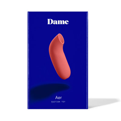 Dame Aer Air Pulse Stimulator in coral pink displayed on blue packaging box with white text.