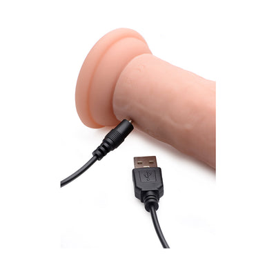 Close-up of a light silicone dildo with a USB charging cable connected to its base.