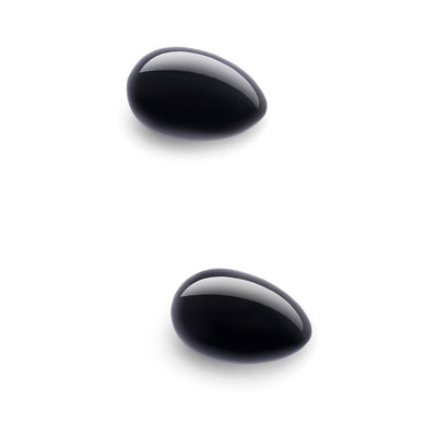 Two polished black obsidian yoni eggs with smooth, glossy surfaces on a white background.