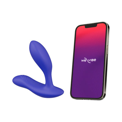 Blue adjustable-fit We-Vibe Vector+ prostate massager next to a smartphone displaying the We-Vibe app interface.