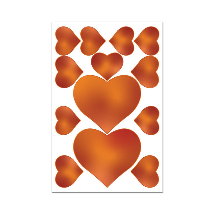Sheet of caramel-colored edible heart-shaped pasties and pecker wraps on a white background.