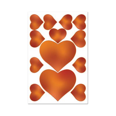 Sheet of caramel-colored edible heart-shaped pasties and pecker wraps on a white background.