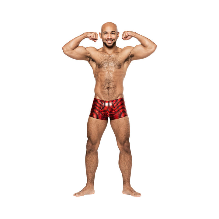 Smiling man flexing muscles wearing Male Power Disco Desire red and black holographic mini shorts on white background.