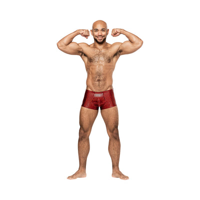 Smiling man flexing muscles wearing Male Power Disco Desire red and black holographic mini shorts on white background.