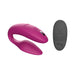 Magenta We-Vibe Sync couples vibrator with textured silicone and black remote control with multiple buttons.