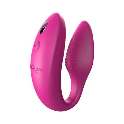 Pink We-Vibe Sync couples vibrator with adjustable arms and textured silicone surface, designed for shared pleasure.