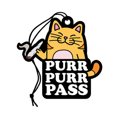 Cartoon orange cat air freshener with "Purr Purr Pass" text and a string for hanging, green grass scent.
