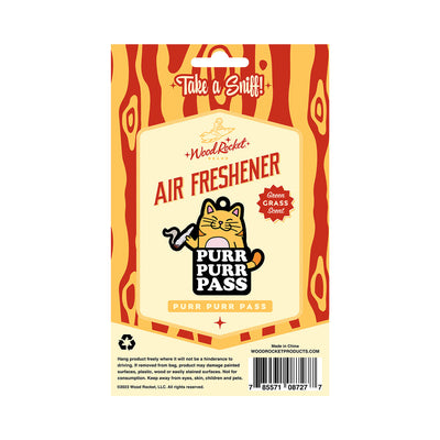 Wood Rocket Purr Purr Pass air freshener packaging with cartoon cat and green grass scent label.