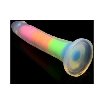 Rainbow glow-in-the-dark silicone dildo with suction base on black background.