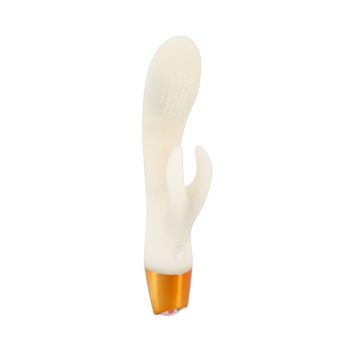 Glow-in-the-dark white silicone rabbit vibrator with textured shaft and gold base on white background.