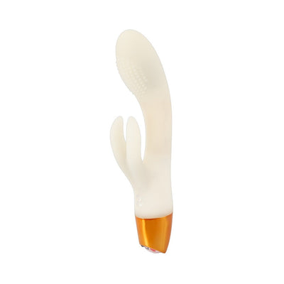 Glow-in-the-dark white silicone rabbit vibrator with textured tip and dual stimulation arms, featuring a gold base.