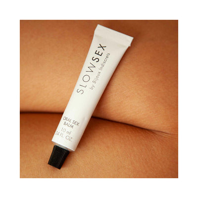 Tube of Bijoux Indiscrets Slow Sex Oral Sex Balm resting on smooth skin background.