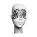 Black ornate decal eyemask with intricate scrollwork displayed on a white mannequin head