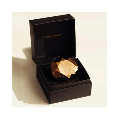 Bijoux Indiscrets Twenty One Vibrating Diamond in amber color displayed in an open black gift box.