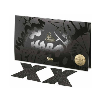 Black glittery cross-shaped reusable pasties with sleek black packaging featuring comic-style text accents.