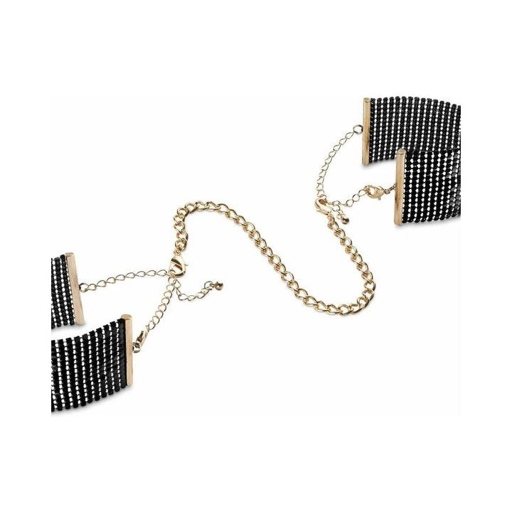 Black metallic mesh handcuff bracelets connected by a gold-tone adjustable chain on white background.