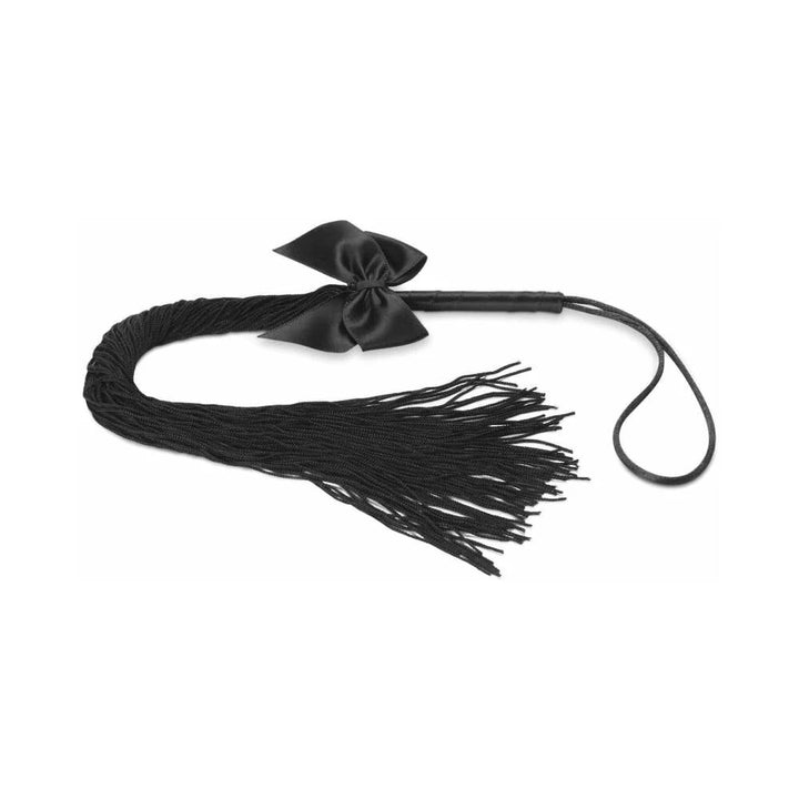 Black soft-tassel whip with a satin bow and wrist loop, designed for playful and sensual exploration.