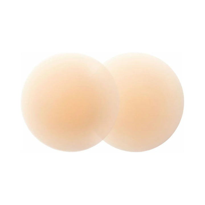 Pair of round, creme-colored ultra-thin reusable silicone nipple covers for smooth, discreet skin coverage.
