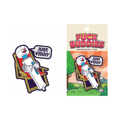 Colorful enamel pin featuring a relaxed cartoon wand vibrator lounging in a chair with a speech bubble saying Just Vibin'