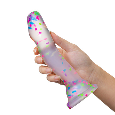 Hand holding a 7.5-inch clear silicone dildo with colorful neon confetti and a suction cup base.
