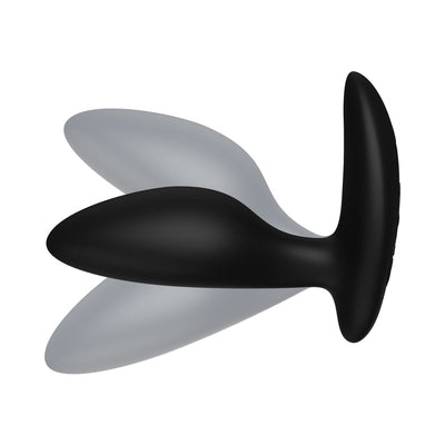 Black silicone vibrating anal plug with ergonomic shape and flared base, shown with motion blur effect.