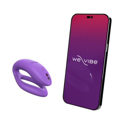 Purple We-Vibe Sync O couples vibrator next to a smartphone displaying the We-Vibe app interface.