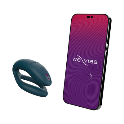 We-Vibe Sync O couples vibrator in dark teal with smartphone displaying We-Vibe app interface on white background.