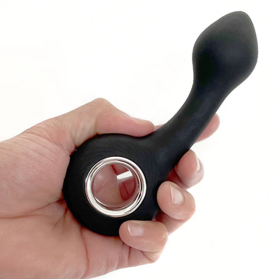Hand holding a black silicone G-spot vibrator with a circular handle and ergonomic curved tip.