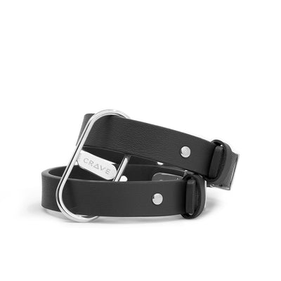 Black genuine leather cuffs with polished silver-tone stainless steel hardware and adjustable buckle closure.