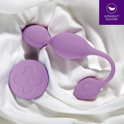 Lilac Wellness Raine vibrating kegel ball with wireless remote on white satin fabric, made from Ultrasilk silicone.