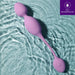 Lilac Wellness Raine vibrating kegel ball resting in water with IPX7 waterproof icon visible.