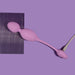 Lilac Wellness Raine vibrating kegel ball with smooth silicone surface on purple background, shown with charging cable attached.