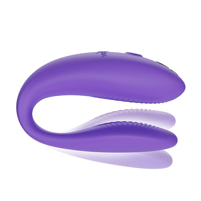 Purple We-Vibe Sync Go couples vibrator with flexible ergonomic design and textured inner arms for dual stimulation.